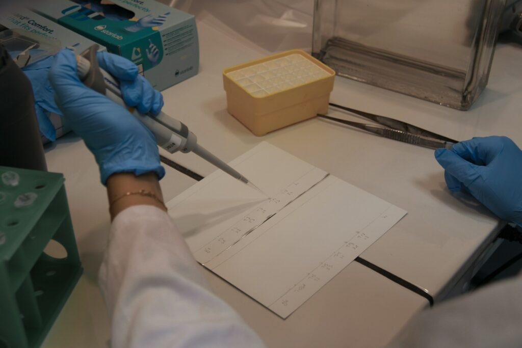 Scientist uses pipette in a laboratory experiment.