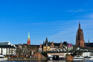 A bridge over a body of water with buildings in the background