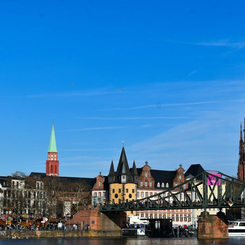 A bridge over a body of water with buildings in the background
