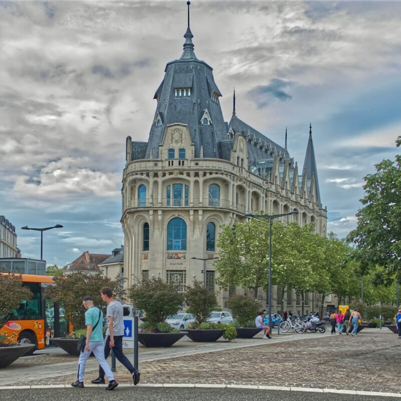 a couple of people walking across a street
