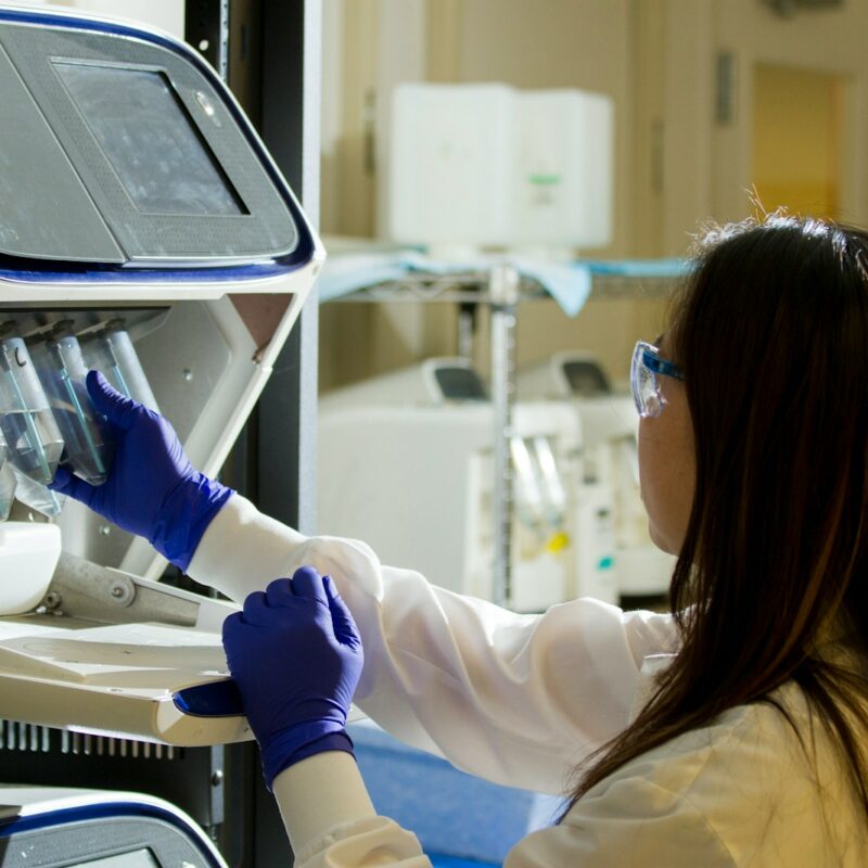 woman in white long sleeve shirt wearing blue gloves